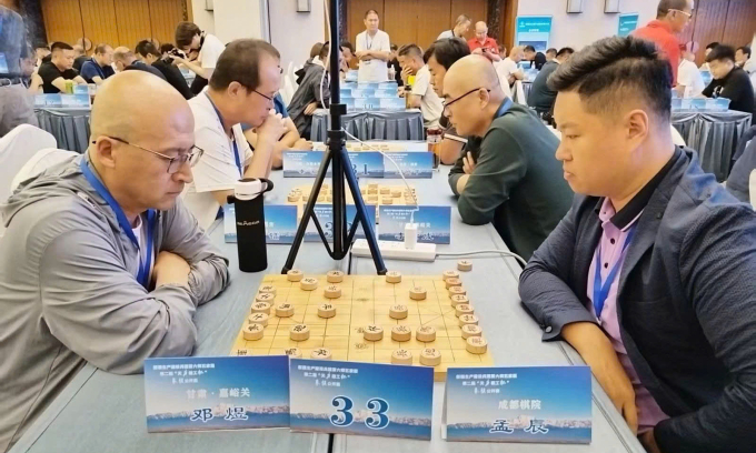 Mạnh Thần (phải) trong một ván đấu tại giải Thiên Lực Kiến Công ở thành phố Ngũ Gia Cừ, khu tự trị Tân Cương, Trung Quốc ngày 14/7/2025. Ảnh: Sohu